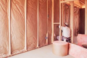 installing-insulation-into-wall-of-new-home-74065310-580f7e0b3df78c2c739b6833