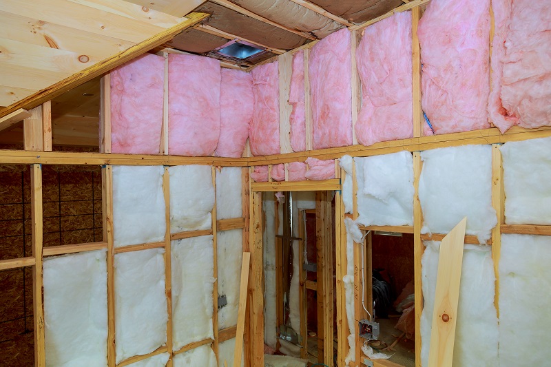 Wooden frame for future walls insulated with rock wool and fiberglass insulation Residential Insulation Contractors Fiberglass Installation