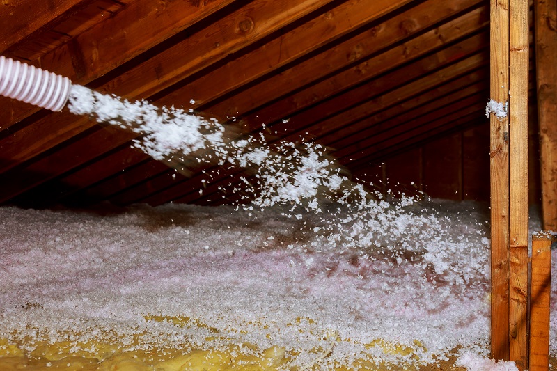 Worker Spraying mineral rock wool of house attic insulation attic Insulation companies In Kansas City #224432835 (AdobeStock) Star Companies, Inc.